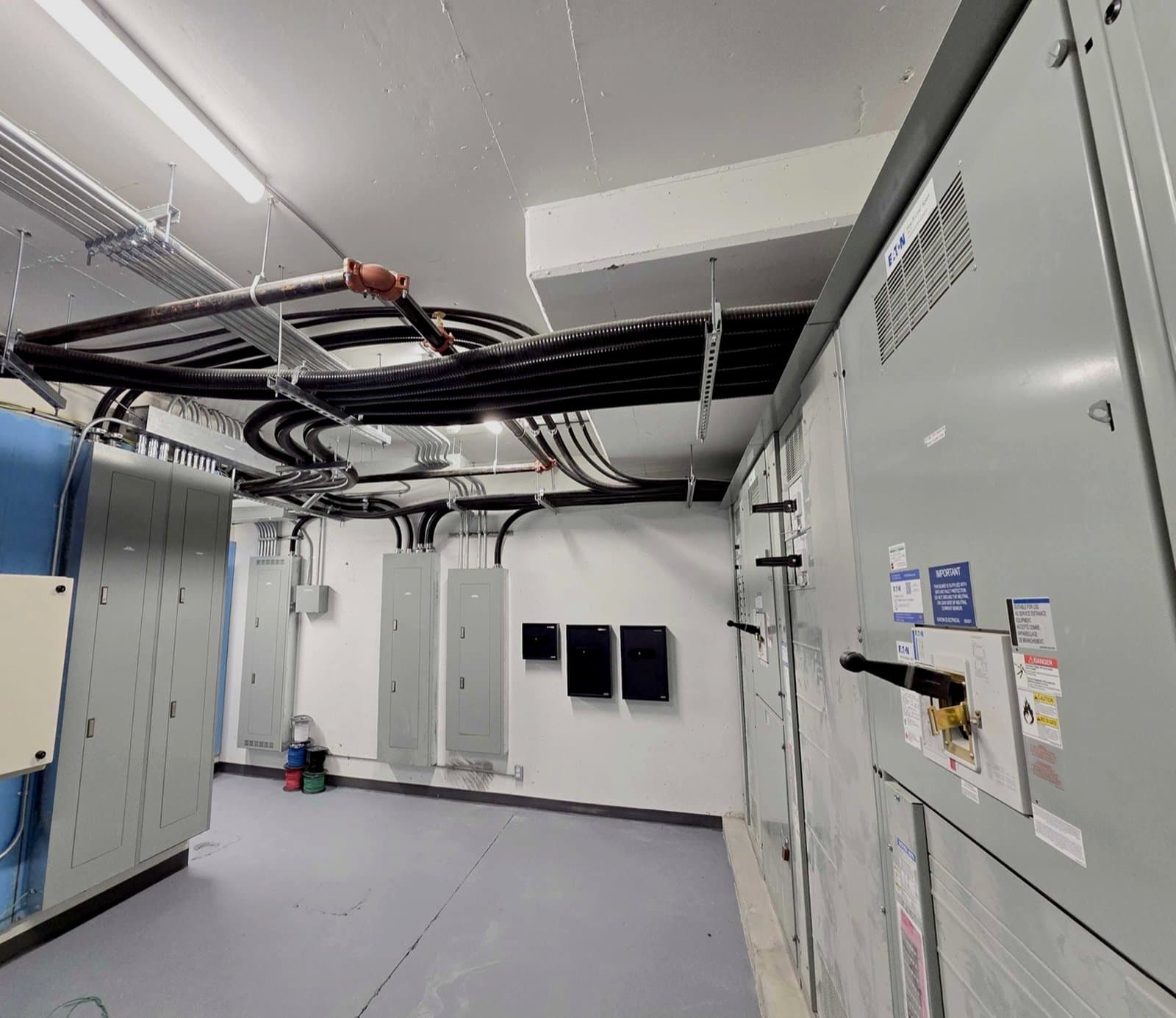 Electrical room wired by K-Jay with switchgear, distribution panels, and overhead teck cable runs